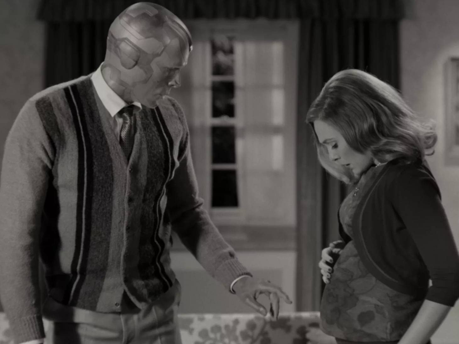 wanda and vision with wanda displaying her pregnant belly in wandavision