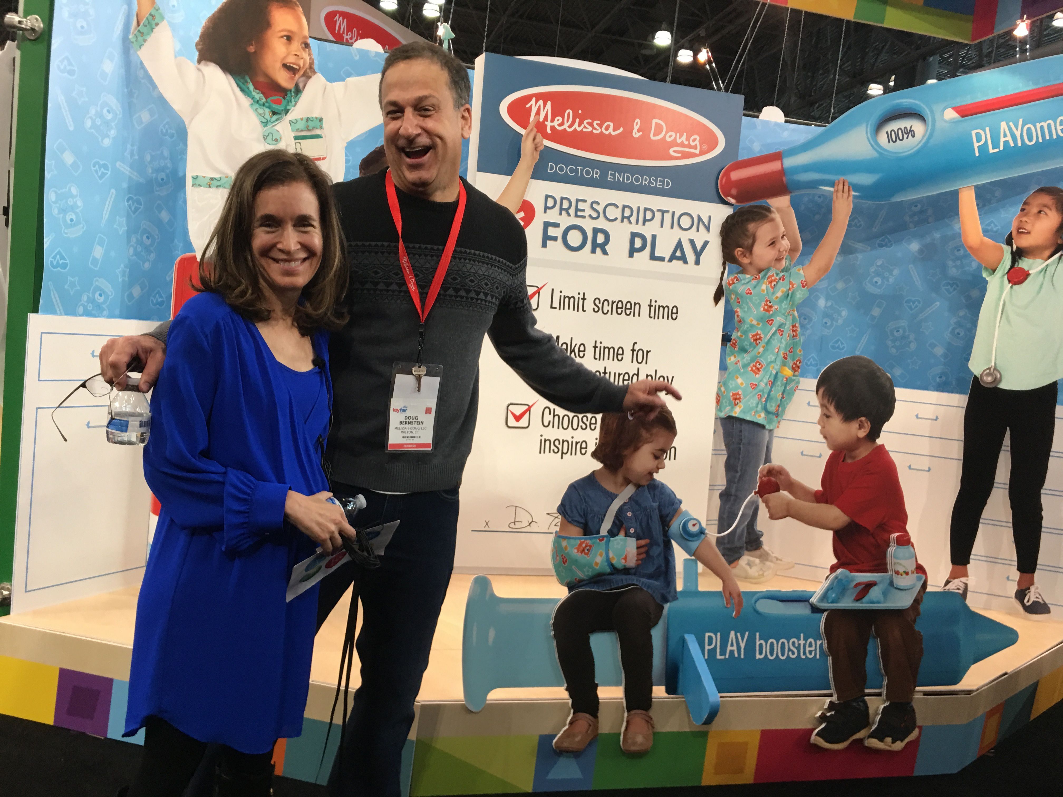 Melissa and Doug Bernstein stand in front of a display promoting Melissa and Doug toys melissa and doug bernstein of melissa and doug
